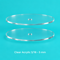 Set of 2 clear round acrylic cake disks with center hole on a turquoise background