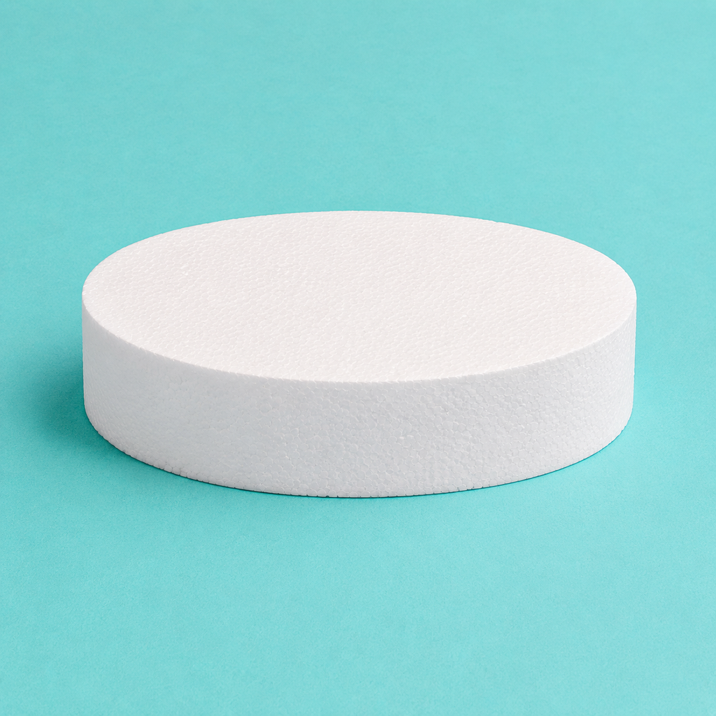 Oval foam cake dummy 10 by 7 inch, 3 inches tall, seen from the front showing the perpendicular side and crisp top rim