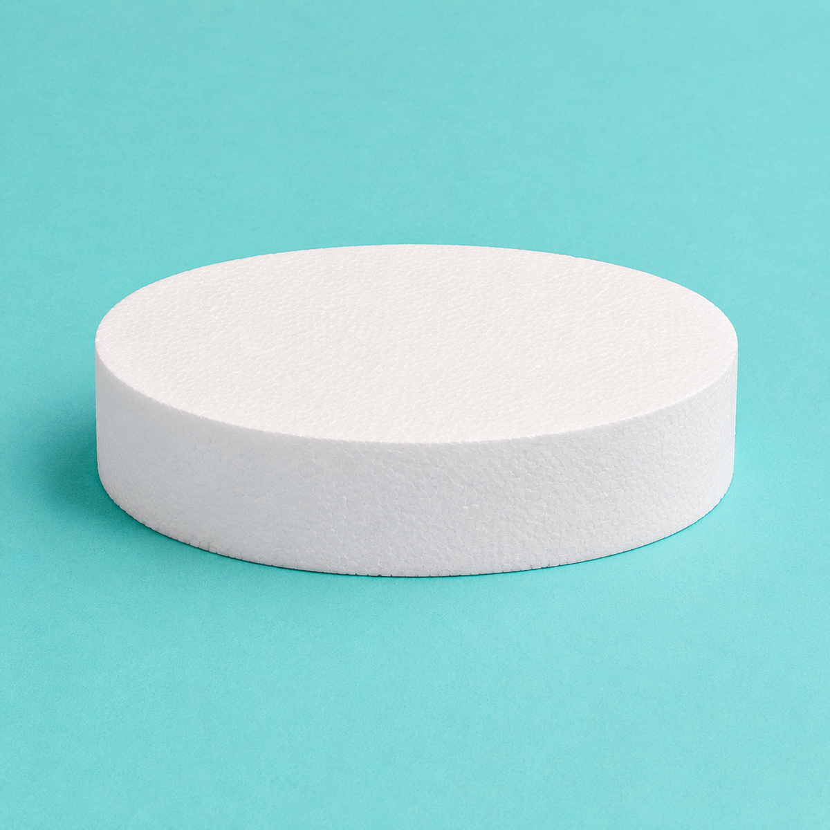 Oval foam cake dummy 10 by 7 inch, 3 inches tall, seen from the front showing the perpendicular side and crisp top rim
