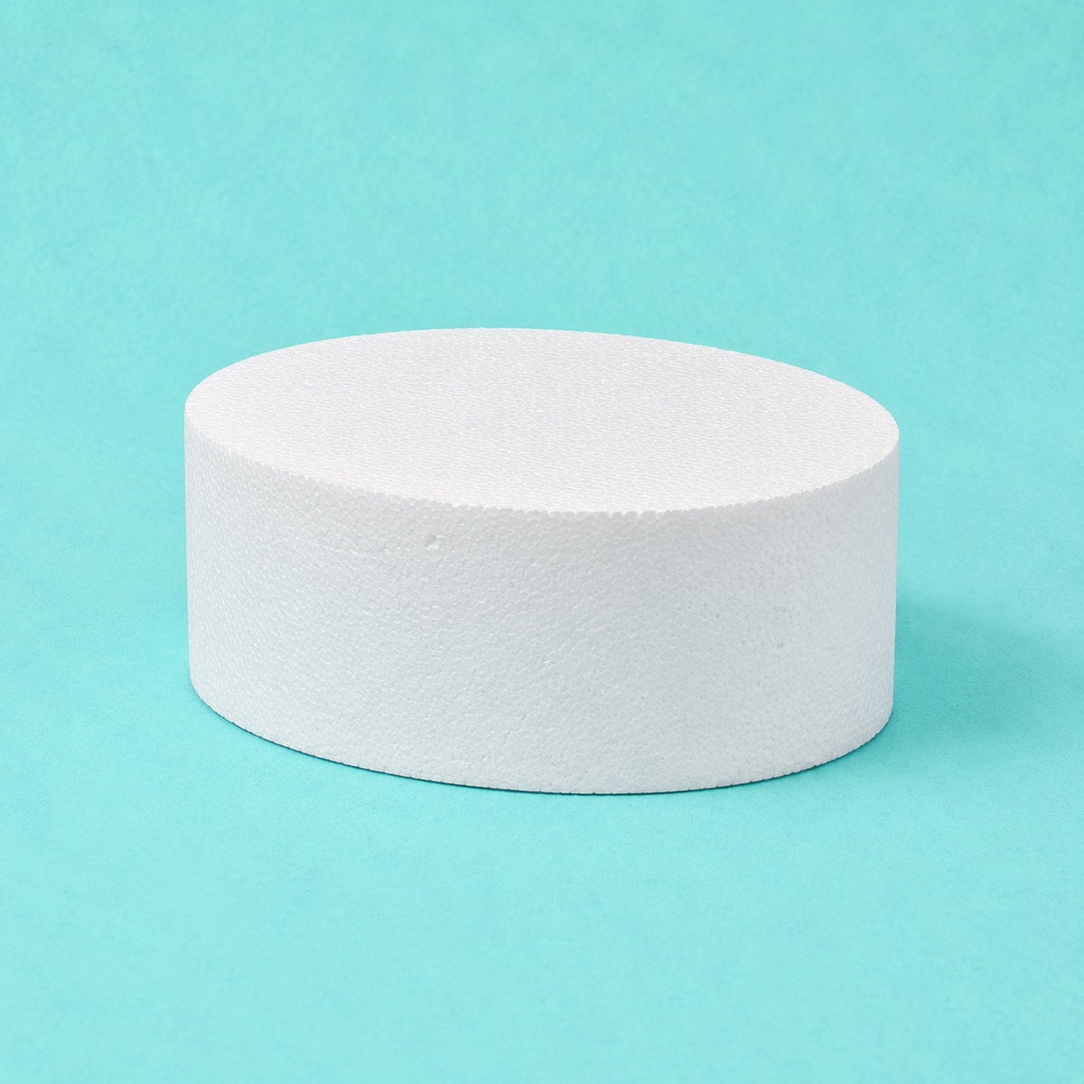 Oval foam cake dummy 10 by 7 inch, 5 inches tall, seen from the front showing the perpendicular side and crisp top rim