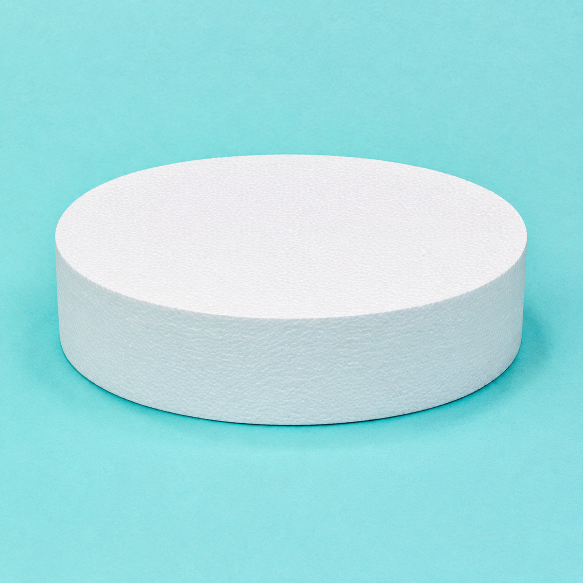 Oval foam cake dummy 12 by 9 inch, 4 inches tall, seen from the front showing the perpendicular side and crisp top rim