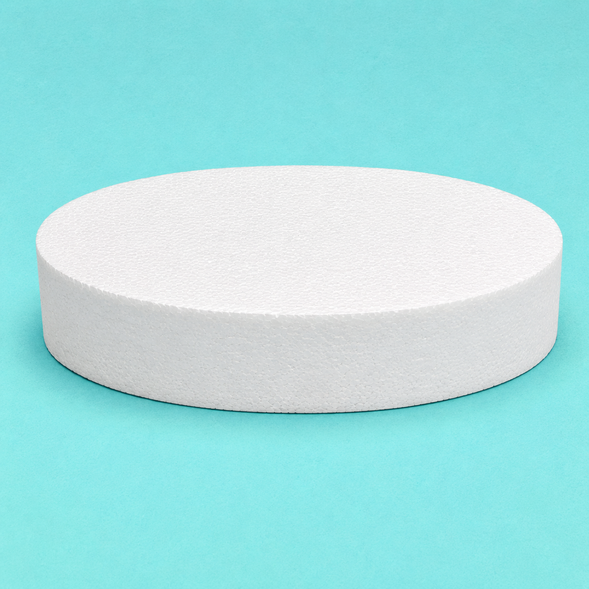Oval foam cake dummy 14 by 10 inch base tier, 3 inches tall, seen from the front showing the perpendicular side and crisp top rim