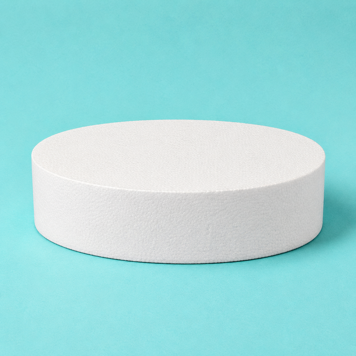 Oval foam cake dummy 14 by 10 inch base tier, 5 inches tall, seen from the front showing the perpendicular side and crisp top rim