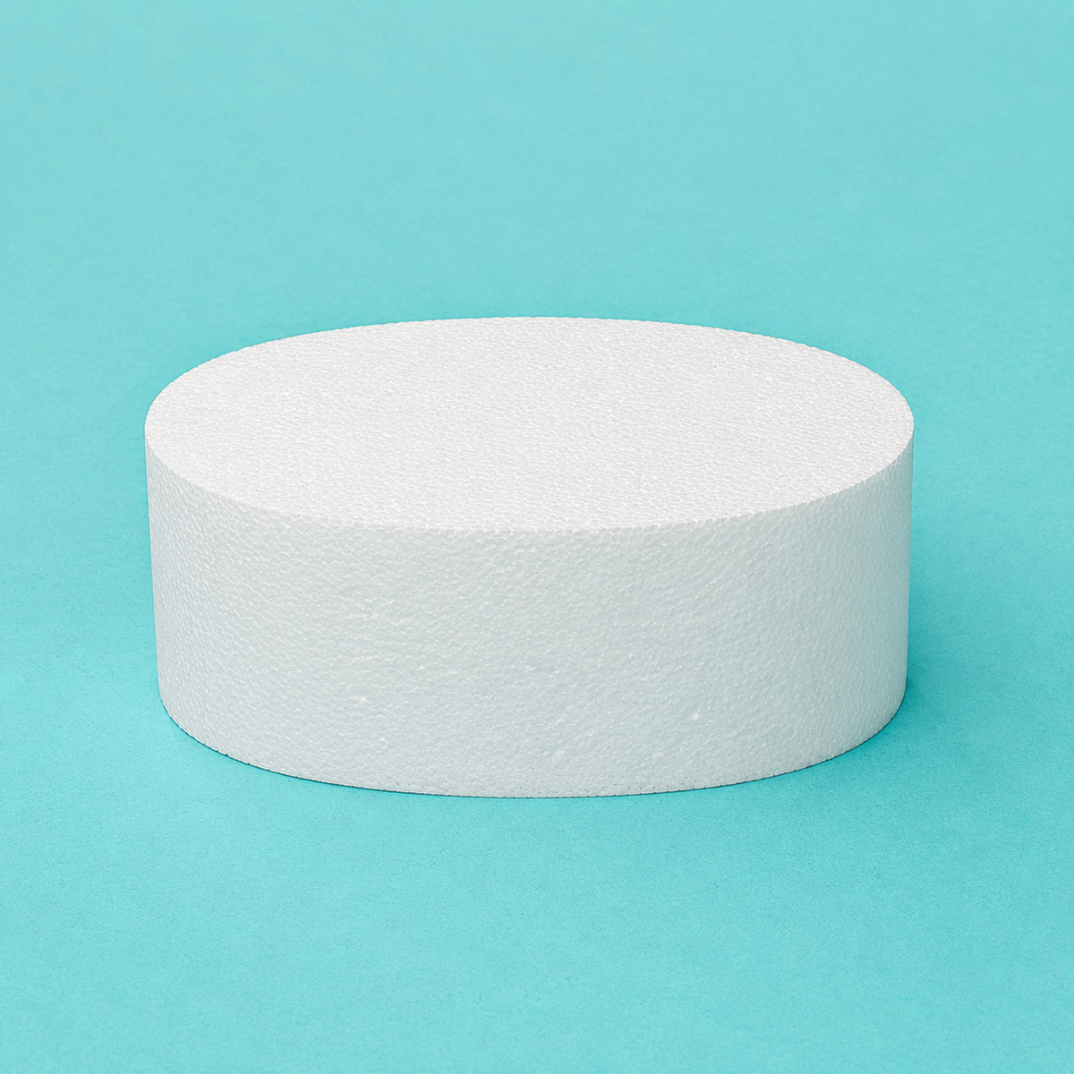 Oval foam cake dummy 8 by 6 inch, 4 inches tall, seen from the front showing the perpendicular side and crisp top rim