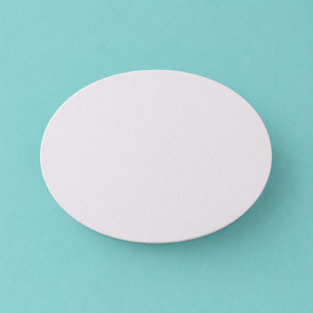 Oval foam cake dummy 8 by 6 inch, seen from above showing the true elliptical profile, smooth white finish