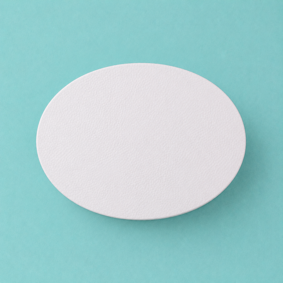 Oval foam cake dummy 8 by 6 inch, seen from above showing the true elliptical profile, smooth white finish