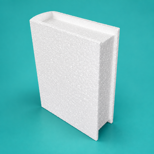 Closed book foam cake dummy lying flat showing raised cover edge and recessed page block on teal background
