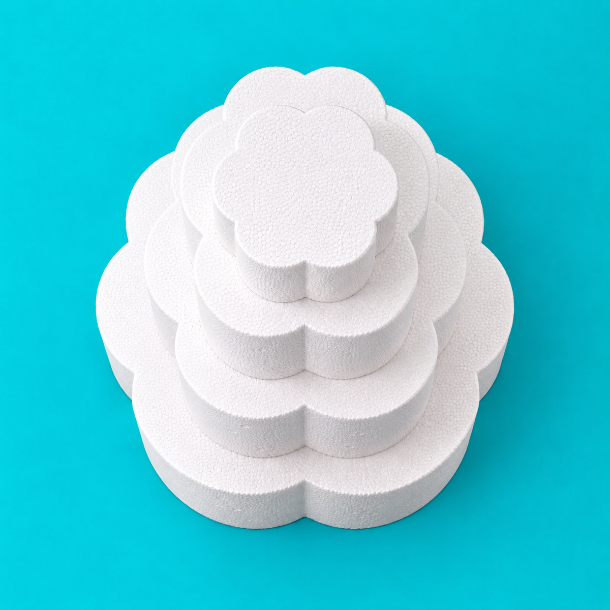 Top view of 4-tier petal-shaped foam cake dummy set, 14, 12, 10 and 8 inch tiers, showing scalloped petal edge, smooth white finish