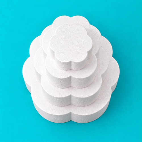 Top view of 4-tier petal-shaped foam cake dummy set, 14, 12, 10 and 8 inch tiers, showing scalloped petal edge, smooth white finish